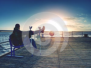 Tourist watch sunrise outside at beach bridge