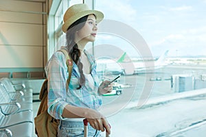 Tourist watching at airport window