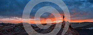 Tourist watching the sunset at the Valle de la Luna, Atacama desert, Chile