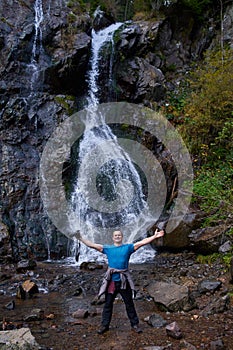 Tourist by the waterfall