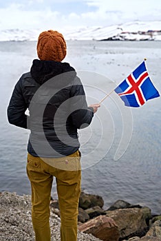 Tourist waving iceland flag