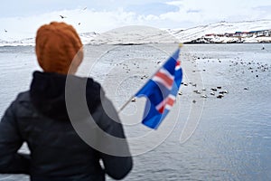 Tourist waving iceland flag