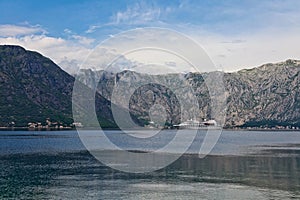 Tourist white cruise sea liner is sailing on the mountain background