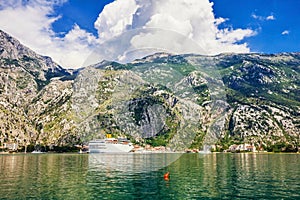 Tourist white cruise sea liner is sailing on the mountain background