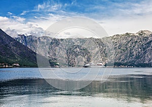 Tourist white cruise sea liner is sailing on the mountain background