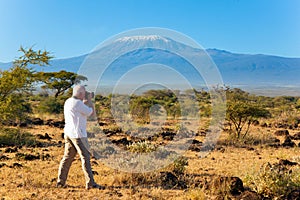 Tourist in a white T-shirt takes pictures