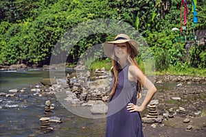 Tourist woman on background of Inuksuk Native Rock Pile in a Creek