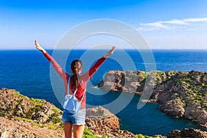 Tourist woman with backpack on Cap de Creus, natural park. Eastern point of Spain, Girona province, Catalonia. Famous tourist