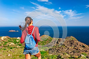 Tourist woman with backpack on Cap de Creus, natural park. Eastern point of Spain, Girona province, Catalonia. Famous tourist