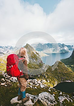 Tourist woman with backpack enjoying view in mountains