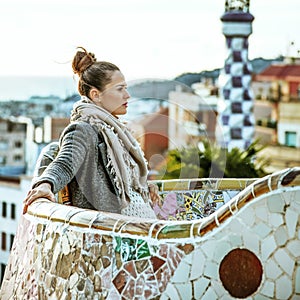 Tourist woman in Barcelona, Spain in winter sitting on bench