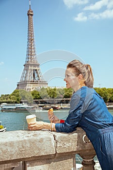 Tourist woman with cup of coffee and croissant