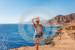 Tourist woman in Dahab near Blue Hole at the Red Sea coast. Famous travel destionation in desert. Sharm el Sheik, Dahab, Sinai photo