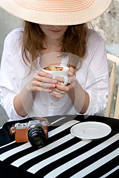 Tourist woman digital camera street cafe terrace girl hat sun vintage travel photo shooting white cup coffee panasonic lumix