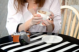 Tourist woman digital camera street cafe terrace girl hat sun vintage travel photo shooting white cup coffee panasonic lumix