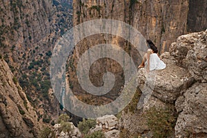 Tourist woman on the edge of a cliff of Tazi Canyon in Manavgat, Antalya, Turkey. Greyhound Canyon, Wisdom Valley.