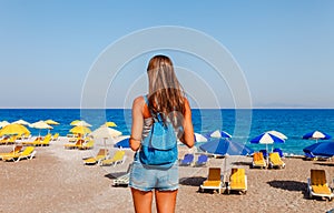 Tourist woman on Elle beach on Rhodes island, Dodecanese, Greece. Panorama with nice sand beach and clear blue water. Famous photo