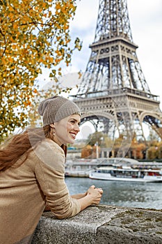 Tourist woman on embankment in Paris, France having excursion