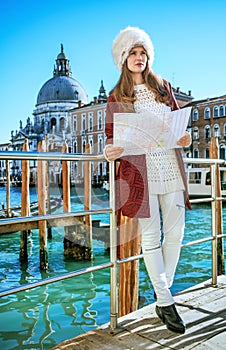 Tourist woman on embankment in Venice exploring attractions