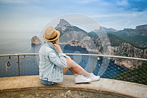 A tourist woman enjoying beauty of Cap Formentor in Mallorca, Spain