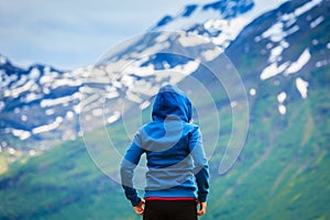 Tourist woman enjoying mountains landscape in Norway.