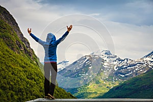 Tourist woman enjoying mountains landscape in Norway.