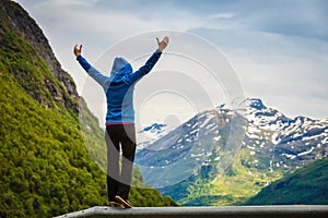 Tourist woman enjoying mountains landscape in Norway.