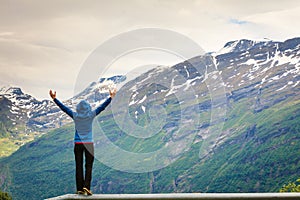 Tourist woman enjoying mountains landscape in Norway.