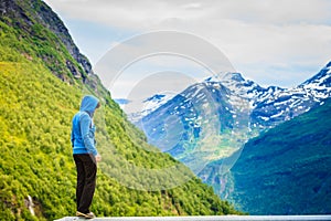 Tourist woman enjoying mountains landscape in Norway.