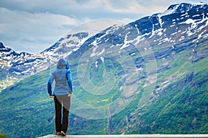 Tourist woman enjoying mountains landscape in Norway.