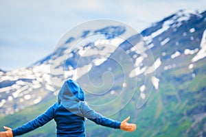 Tourist woman enjoying mountains landscape in Norway.