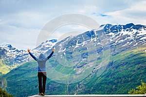 Tourist woman enjoying mountains landscape in Norway.