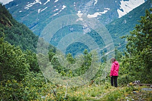 Tourist woman enjoying mountains landscape in Norway.