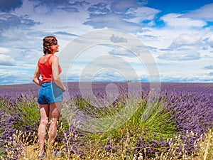 Tourist woman enjoys view of lavender fields, Provence France