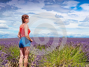Tourist woman enjoys view of lavender fields, Provence France