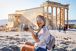 Tourist woman explores the ancient Parthenon temple of the Acropolis of Athens, Greece