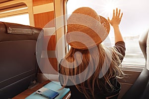 Tourist woman hand looking a window seat on the railway trip