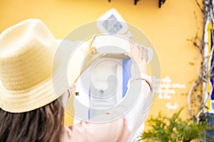 Tourist woman with hat taking photo with smartphone mockup