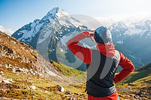Tourist woman hiker on the top of mountain