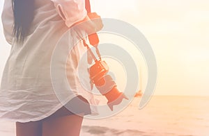 Tourist woman holding camera stand