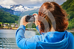 Tourist woman on liner taking photo, Norway