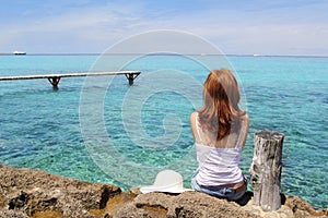 Tourist woman looking Formentera turquoise sea