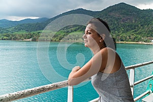 Tourist woman looking at sea view from boat photo