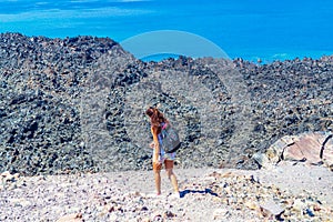 Tourist woman at National Geological Park of Nea Kameni Volcano Greece