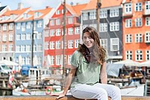 Tourist woman at the Nyhavn harbor pier Copenhagen, Denmark.