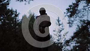 Tourist woman photographer hiking in forest