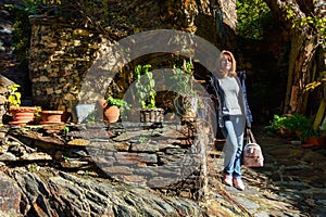 Tourist woman on a picturesque street in the old stone village of Patones de Arriba. photo