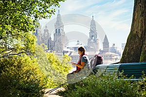 Tourist Woman On Pilgrimage At Santiago De Compostela With Phone