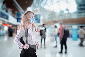 Tourist Woman With Protection Face Mask at The Airport Terminal in Coronavirus Covid-19 Pandemic, Defensive Measure for Travel photo