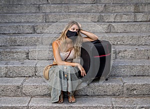 Tourist woman with protective face mask worried about new travel restrictions and quarantine